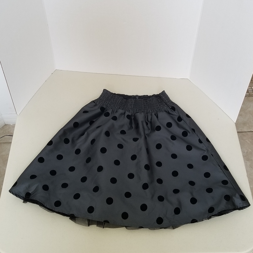 Gray skirt with black polka dots.